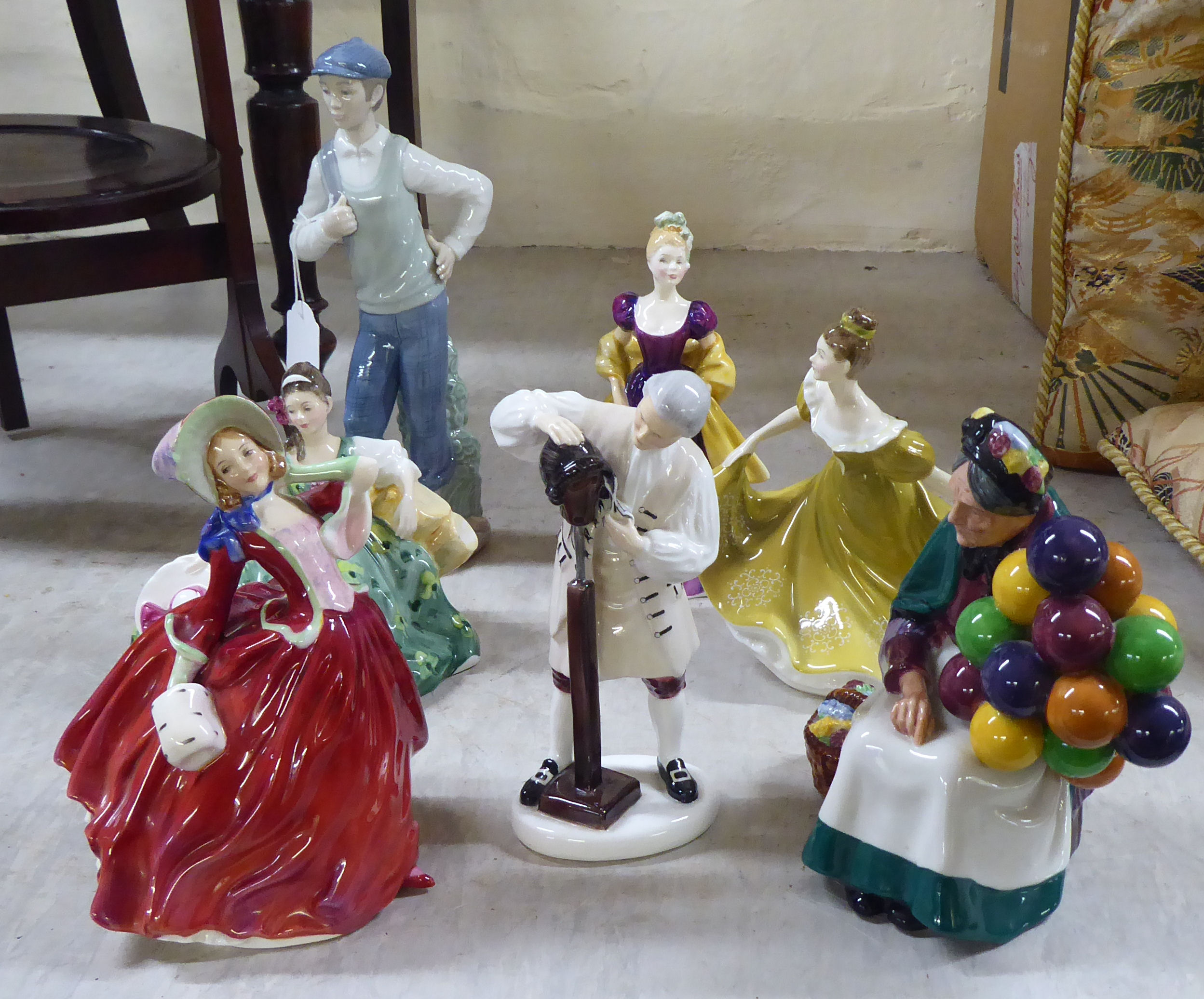 Six Royal Doulton china figures  largest 8"h; and a Nao porcelain figure, a golfer  11"h