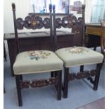 A pair of early 20thC stained beech (possibly European) framed hall chairs, the C-scrolled, carved