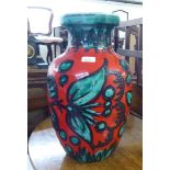 A West German pottery vase, decorated in abstract designs, on a red ground  19"h