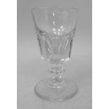 A 19thC wine glass with a part facet cut bucket shaped bowl, on a short, knopped stem and domed foot