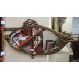 A 20thC mirror, the oval bevelled plate, set in a gilt sprayed cast metal frame  17" x 31"