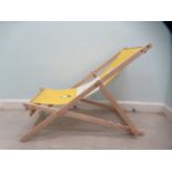 A modern beech framed deck chair, the yellow canvas branded for Penguin Books