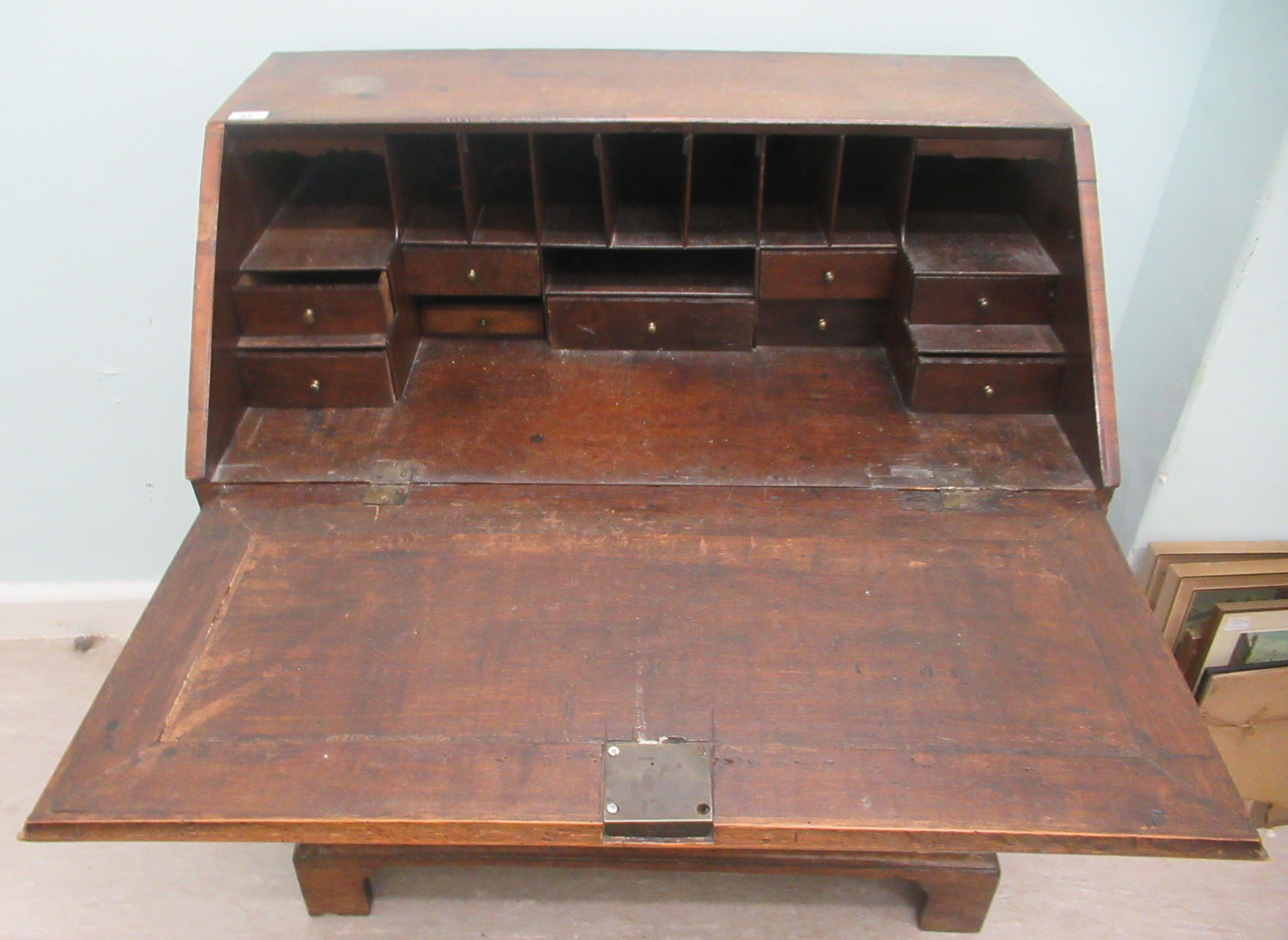 A George III oak bureau, the fall flap over an arrangement of five drawers, raised on bracket - Image 2 of 3