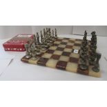 A marble chessboard  13"sq with cast metal chessmen