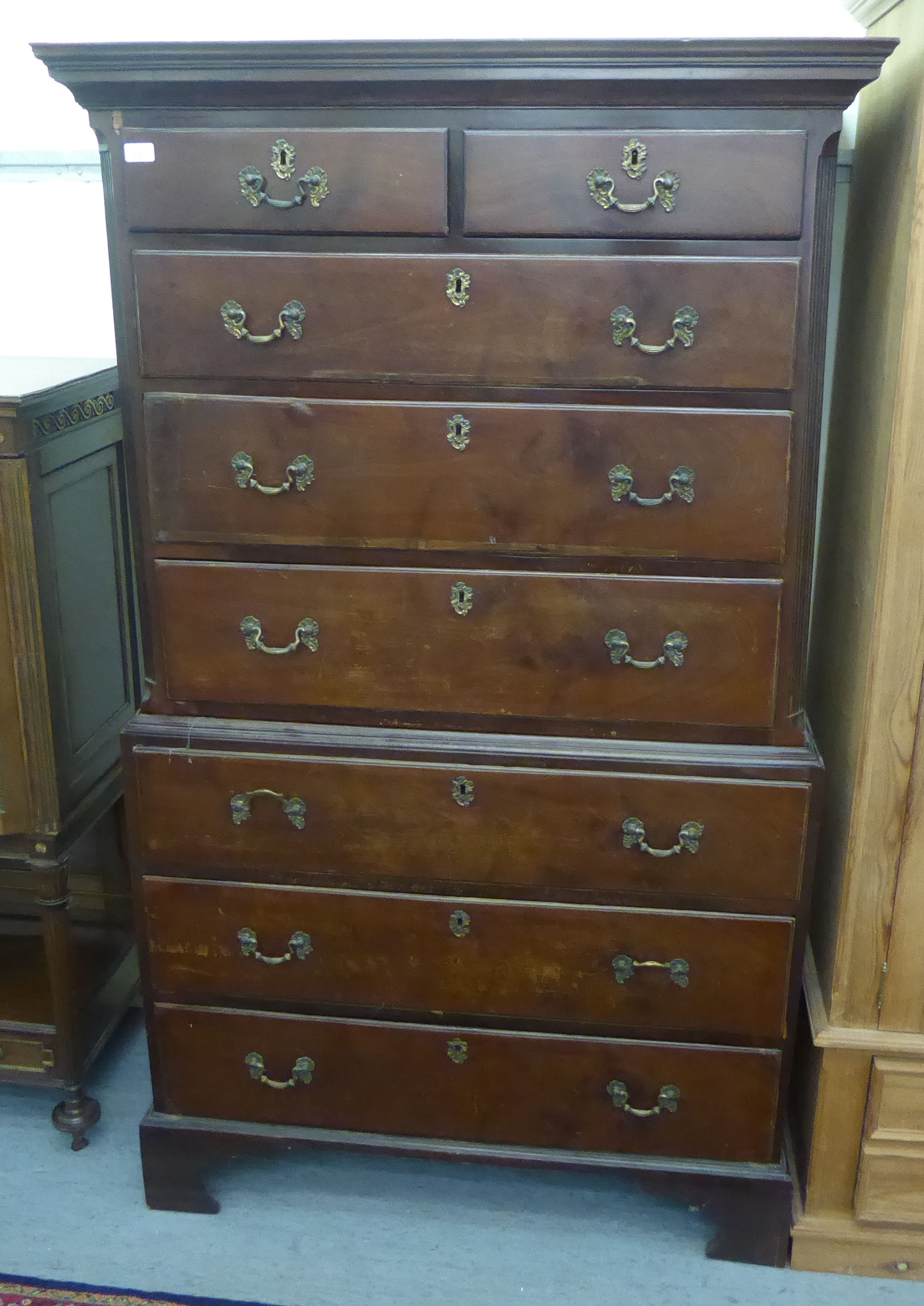 A George III mahogany chest-on-chest with a moulded cornice, over two short/six graduated long