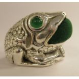 A silver coloured metal novelty pin cushion, fashioned as a seated frog  stamped 925