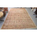 A Persian carpet, decorated with repeating stylised floral designs, on a cream coloured ground  116"