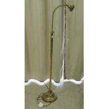 A mid 20thC lacquered brass telescopic standard lamp with an arched arm, accommodating a green glass