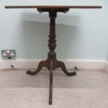 A late 19thC oak tip top pedestal table, on a turned column and tripod base  26"h  23.5"w