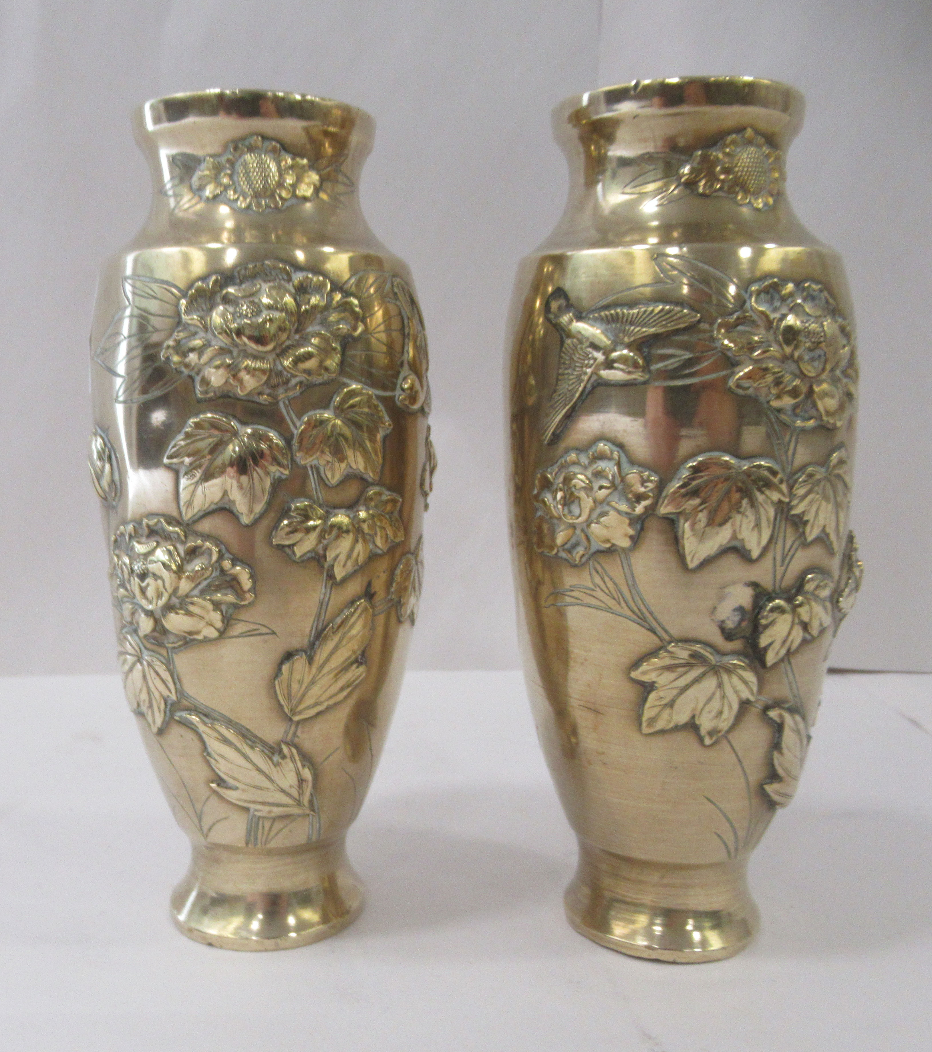 A pair of post 1950s Japanese inspired gilded bronzed vases of tapered form, decorated in relief