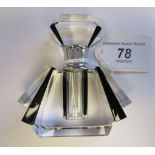 An Art Deco inspired clear and black glass perfume bottle with a chromium plated collar and threaded