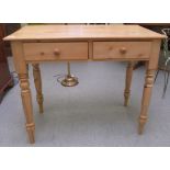 An early/mid 20thC bleached pine two drawer side table, raised on turned legs  30"h  36"w