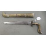 An Indo-Persian dagger with an engraved brass handle, scrolled guard and straight, part wavy edged