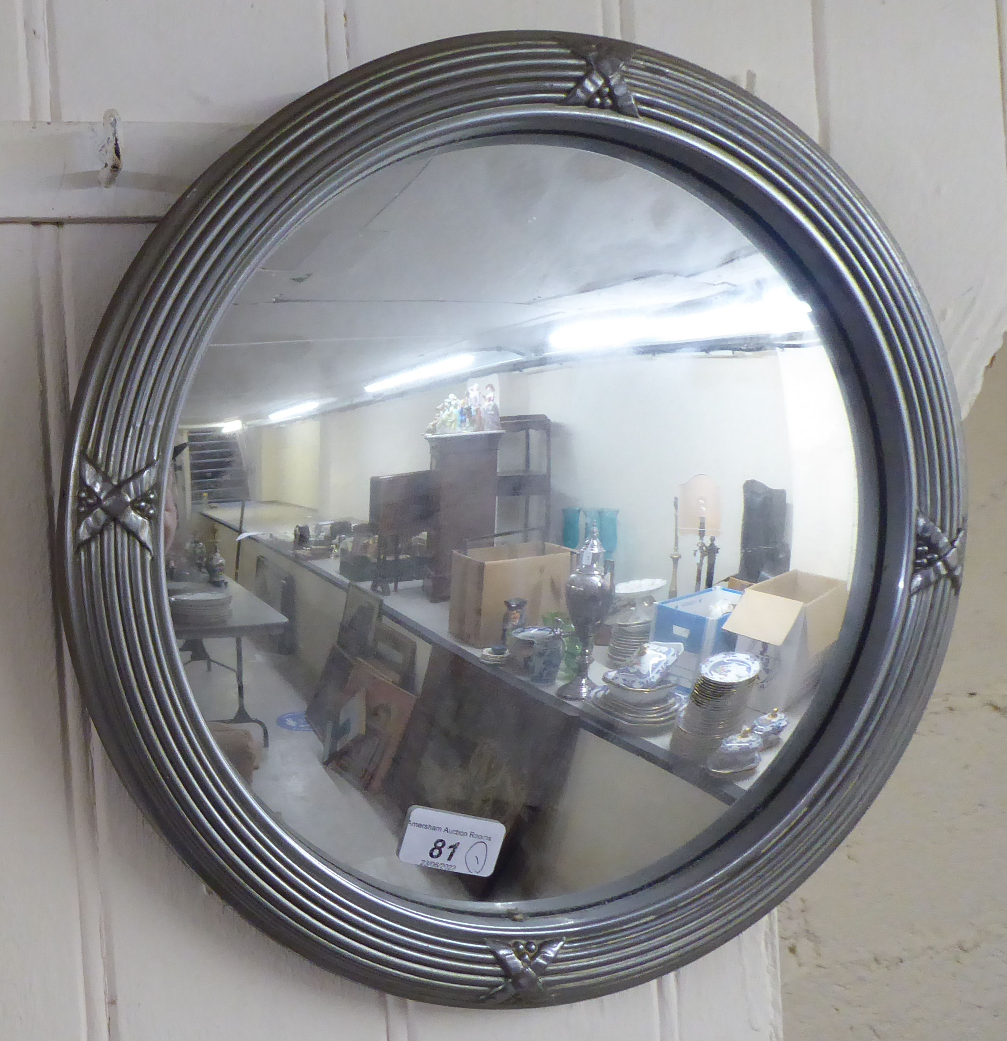 A 20thC mirror, the plate set in a cast metal frame  18"dia