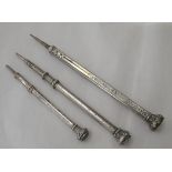 Three early/20thC various white metal propelling pencils, two with hardstone seal ends