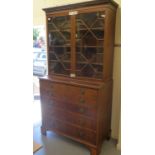 A George III ebony and crossbanded string inlaid mahogany secretaire bookcase with a dentil