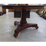 A mid Victorian mahogany centre table, the top over a triangular pedestal and a splayed tripod base