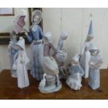 Eight Lladro porcelain figures: to include a young woman standing beside a pail  9"h