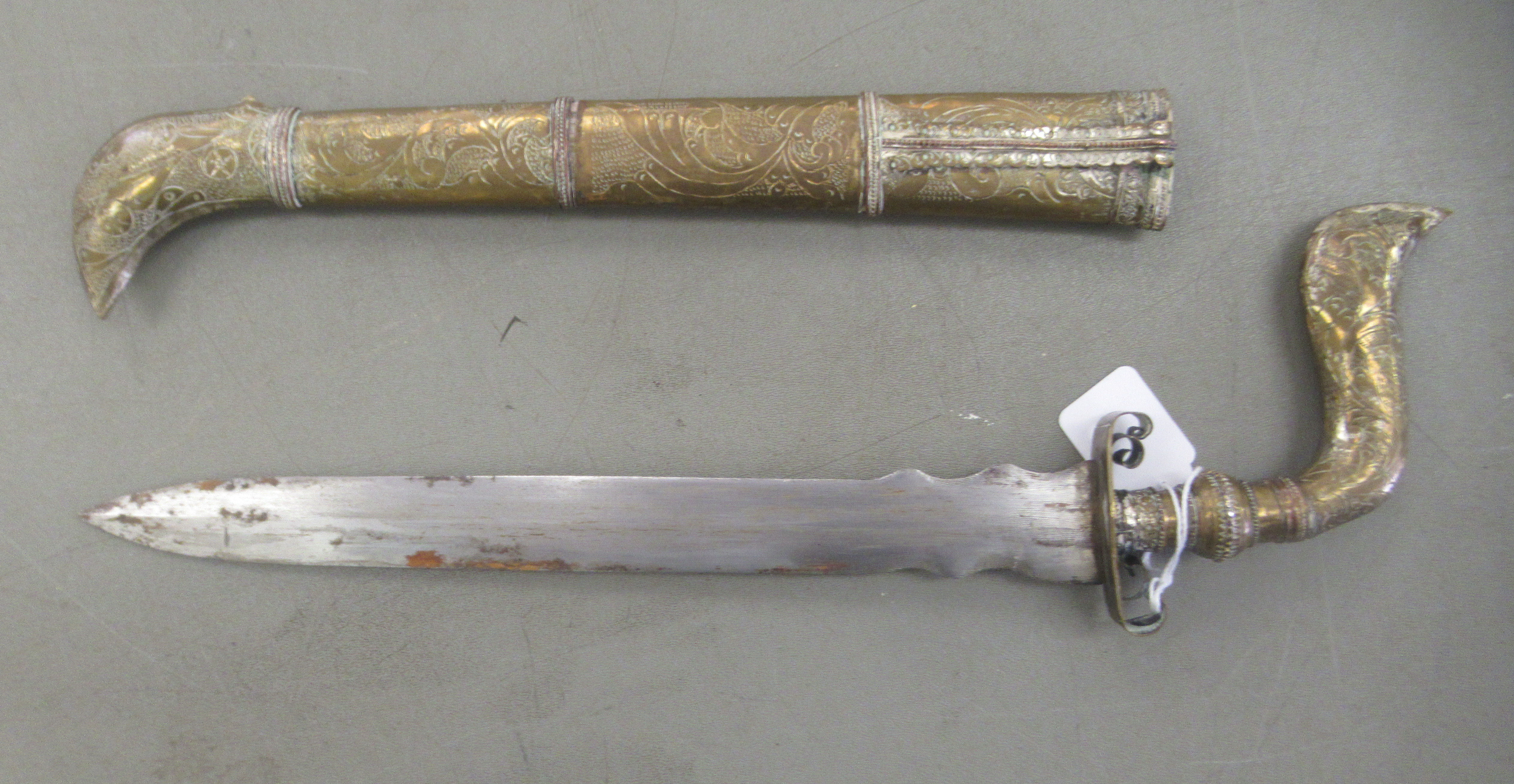 An Indo-Persian dagger with an engraved brass handle, scrolled guard and straight, part wavy edged - Image 2 of 5