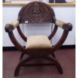 A late 19thC Continental carved oak cross framed chair with a solid, demi-lune crest and level