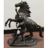 After Guillaume Couston - a cast and patinated bronze statue, a Marly horse and attendant  23"h
