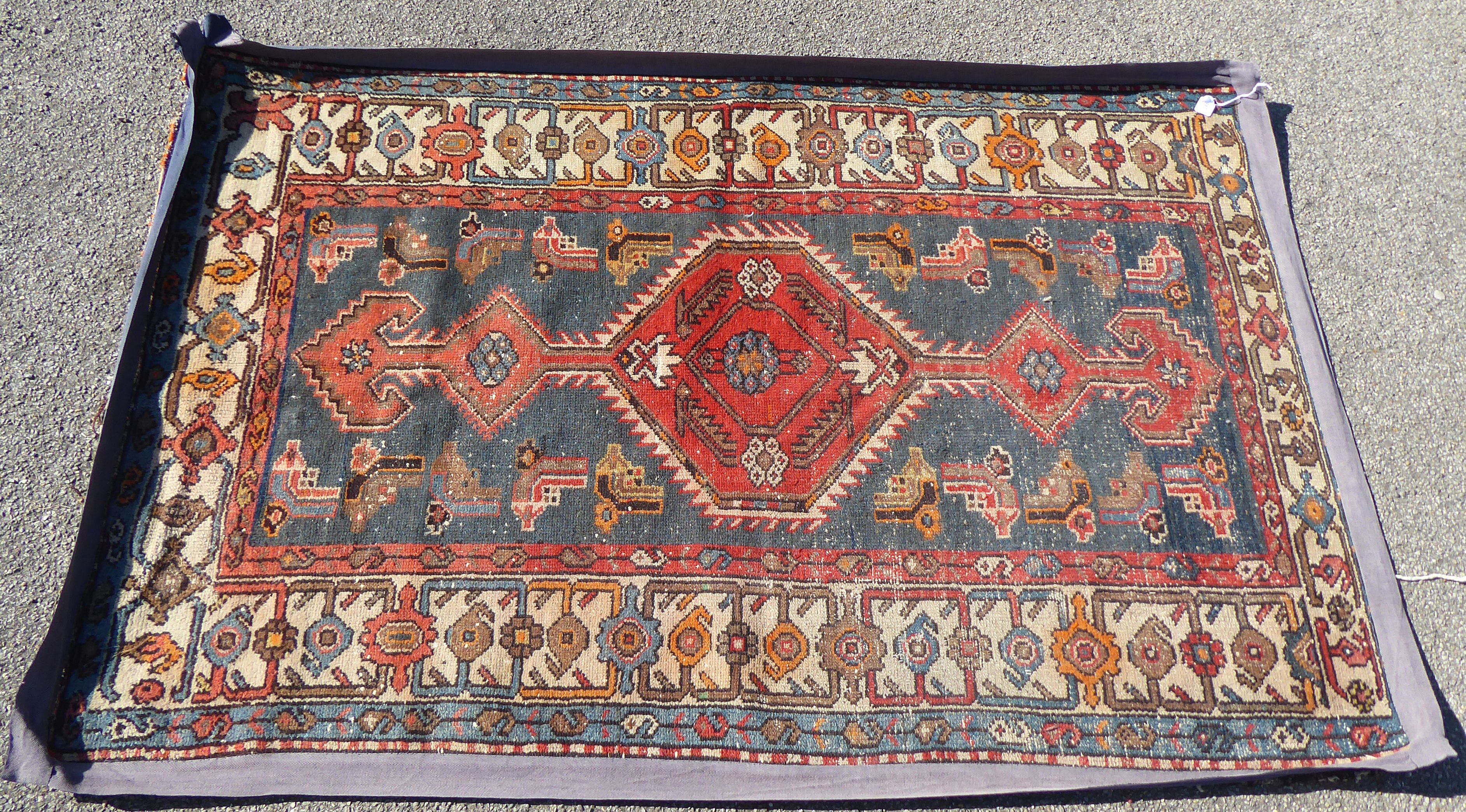 An early 20thC Mazlaghan (Hamadan) rug with central pole medallion, on a blue ground within a