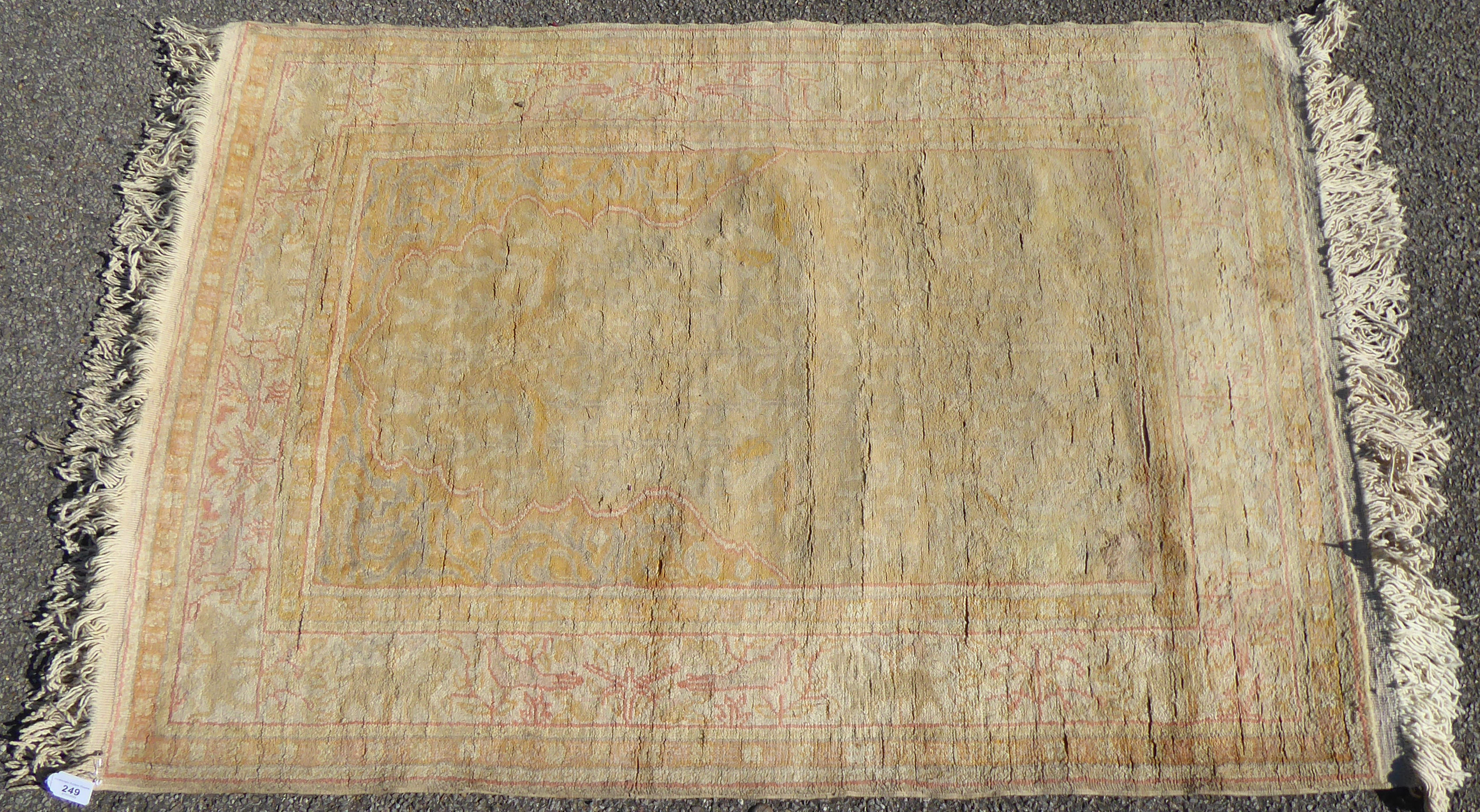 An early 20thC Turkish prayer rug, on a cream coloured ground  52" x 36"