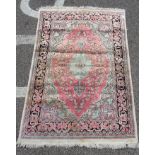 A Kelim part silk rug, decorated with a central serpentine outlined motif, bordered by floral