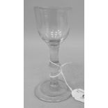 An 18th/19thC wine glass, the small round bowl on a knopped stem and domed foot