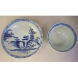 A Chinese Nanking Cargo porcelain tea bowl and saucer, decorated in blue and white with buildings in