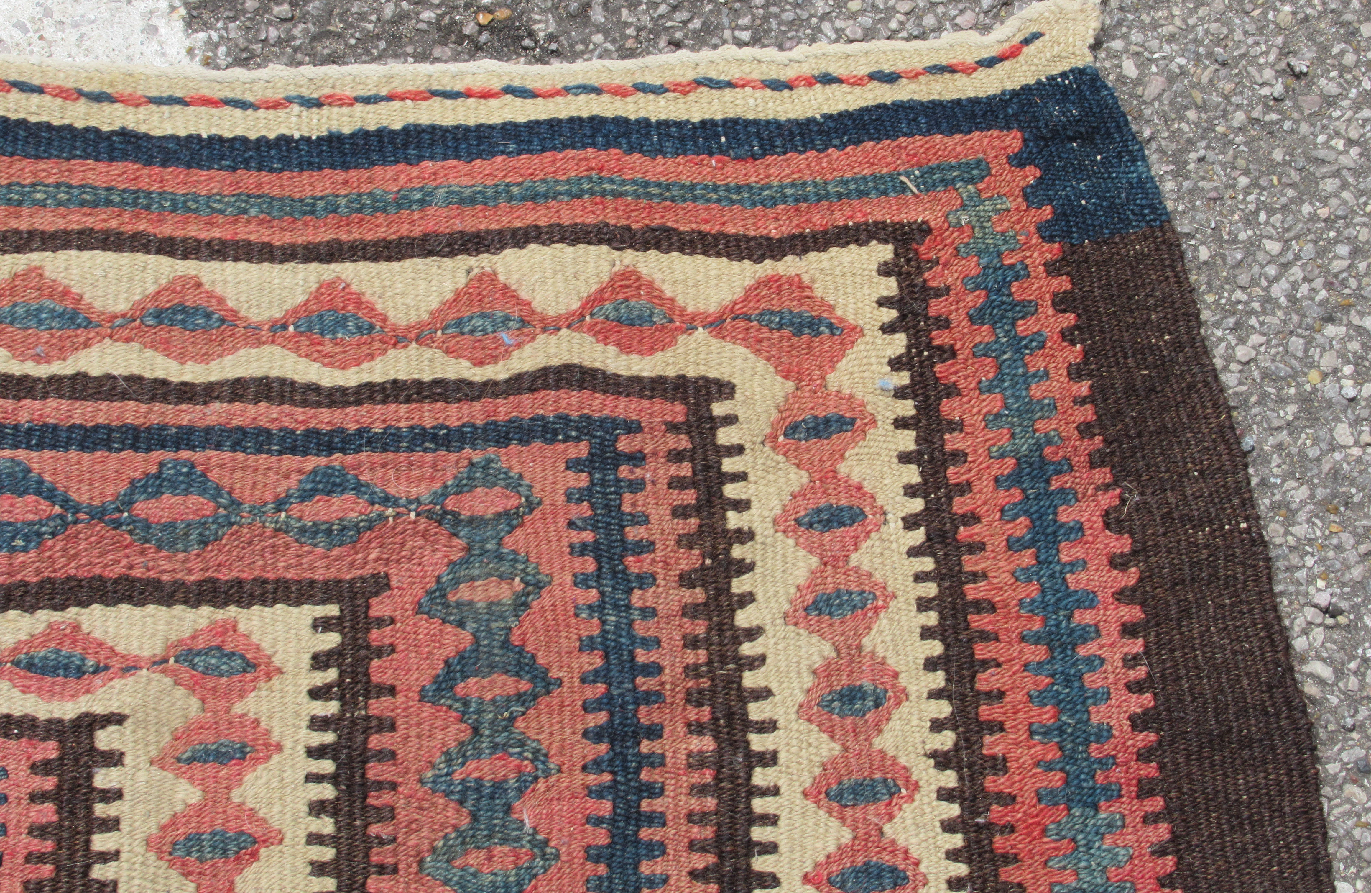 A Turkish Kelim rug, decorated with repeating geometric and other designs, on a brown ground  54" - Bild 3 aus 5