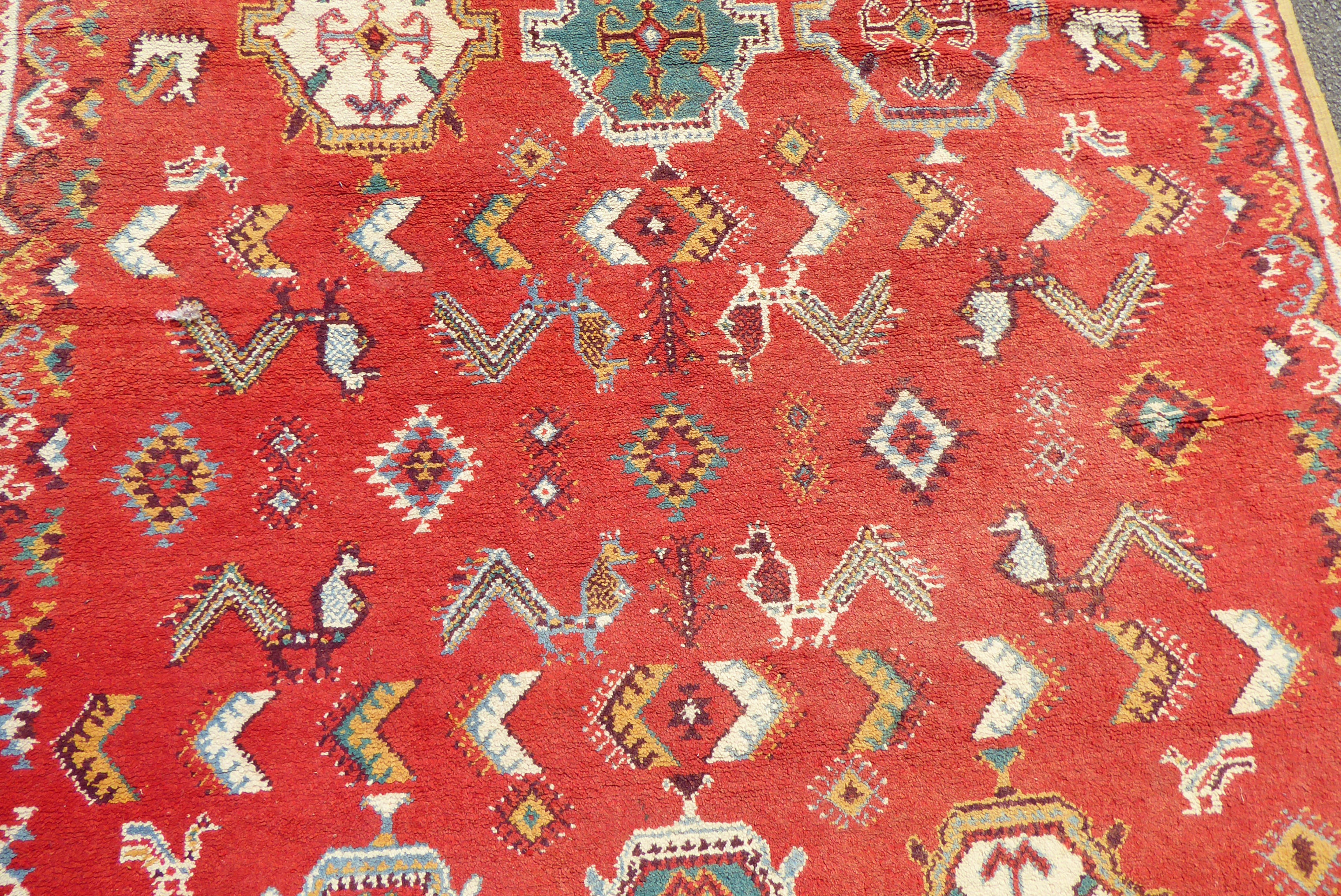 A mid 20thC Turkish carpet with birds and geometric motifs on a red ground  115" x 82" - Bild 4 aus 8