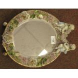 A late 19thC (probably German) oval dressing table mirror, the bevelled plate set in a floral