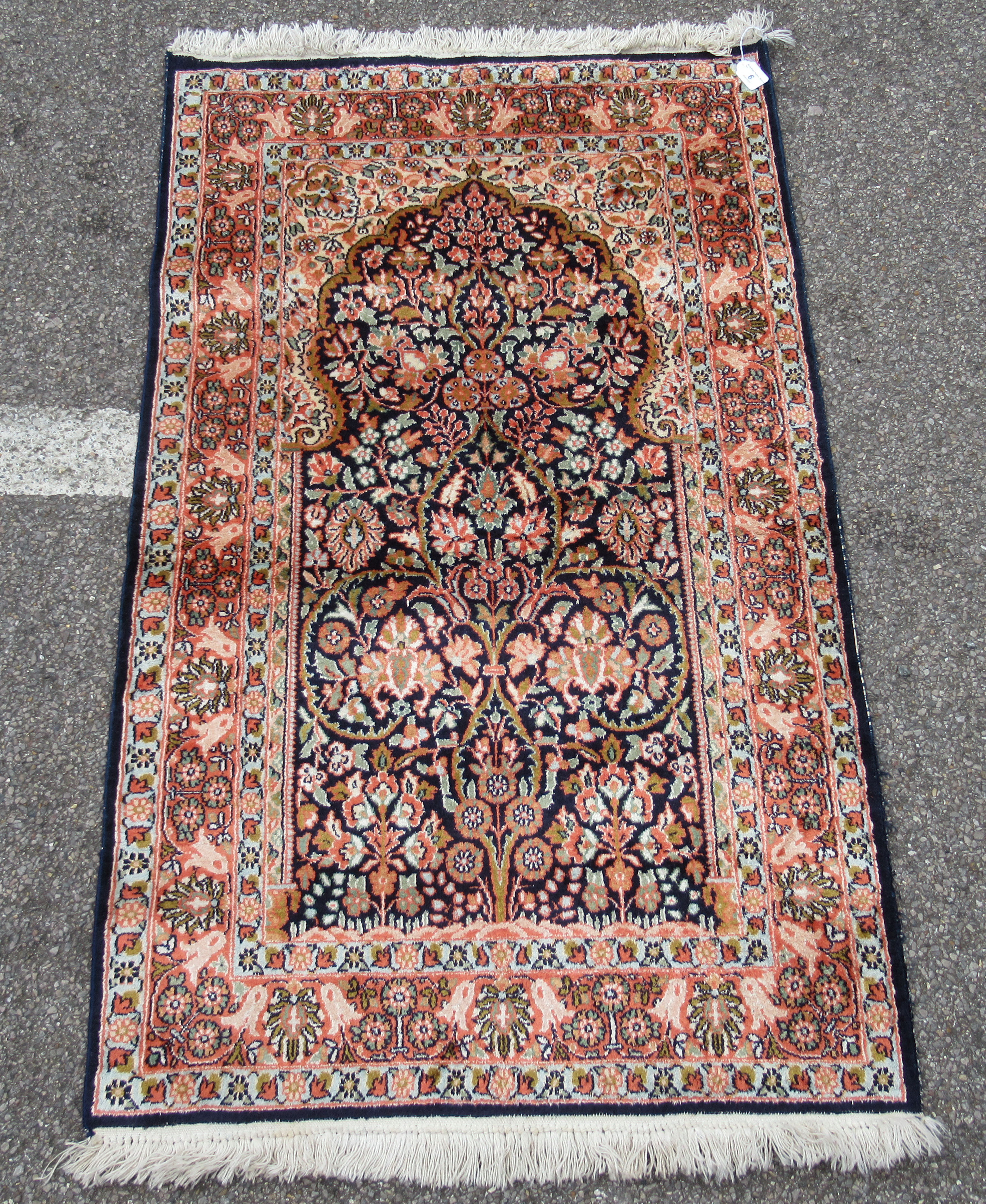 A Kelim part silk prayer rug, decorated with floral designs, on a multi-coloured ground with a