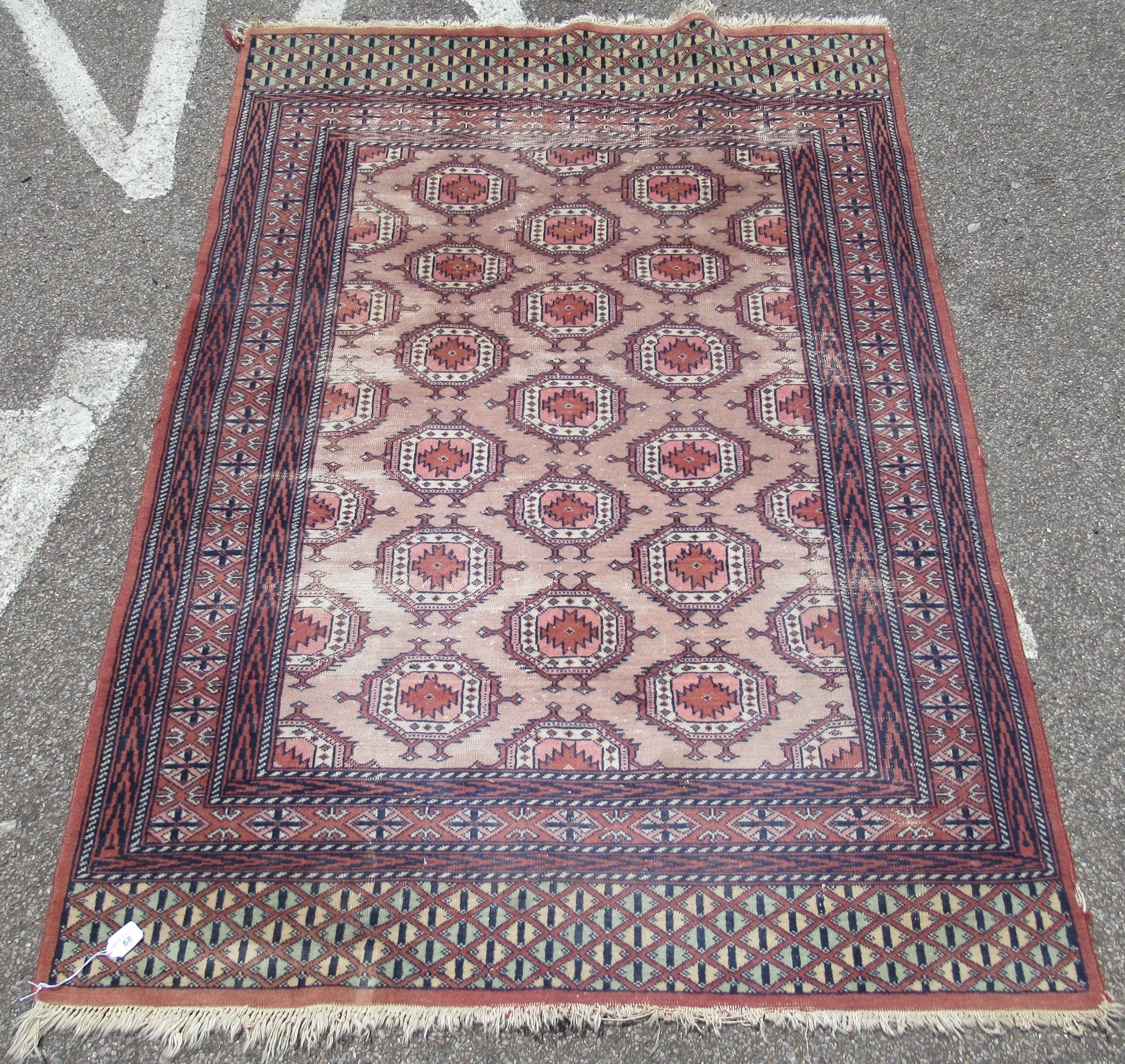 A Bokhara rug, decorated with staggered octagonal motifs, on a multi-coloured ground  48" x 72"