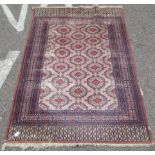 A Bokhara rug, decorated with staggered octagonal motifs, on a multi-coloured ground  48" x 72"