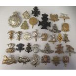 Approx. thirty military regimental cap badges and other insignia, some copies: to include First