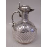 A late Victorian hobnail cut crystal wine decanter of oval bulbous outline with an ornately