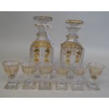 A pair of mid 19thC shouldered, square cut glass liqueur decanters and stoppers with a matching