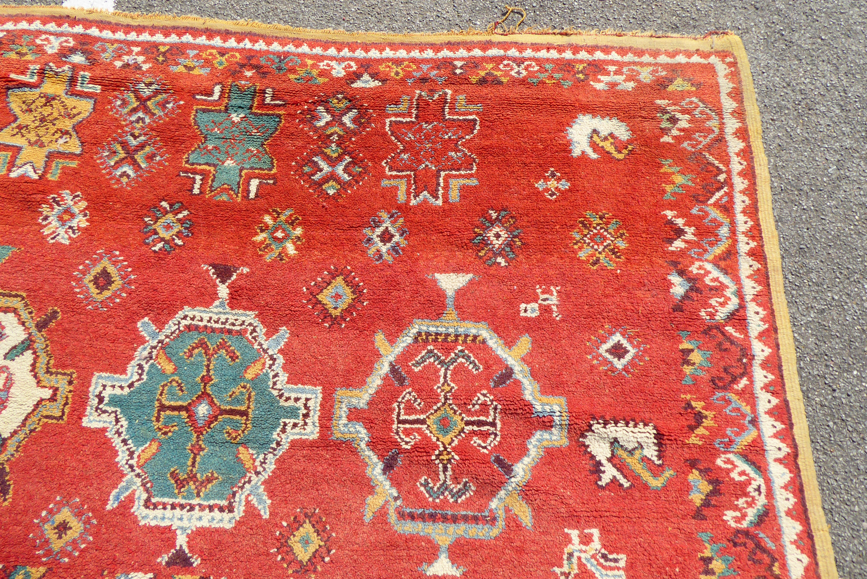 A mid 20thC Turkish carpet with birds and geometric motifs on a red ground  115" x 82" - Bild 6 aus 8