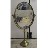 An early 20thC brass framed dressing room toilet mirror, the bevelled plate pivoting/rotating on a