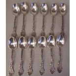 A set of twelve Sterling silver fruit spoons, the decoratively cast stems featuring rococo