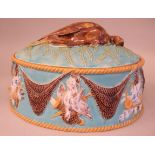 A George Jones majolica oval game dish and cover, moulded with rope effect borders, dead game and