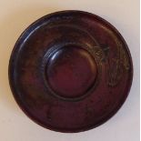 A 19thC Japanese bronze dish with an inset well and flowers in relief  bears a signature  4.5"dia