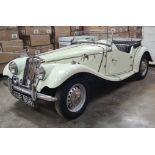 A 1954 MG TF 1250cc petrol two door sports car Registration No. KNR 808 with a tonneau cover and