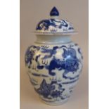 An early 20thC Chinese porcelain blue and white jar and cover decorated with mythical beasts  12"h