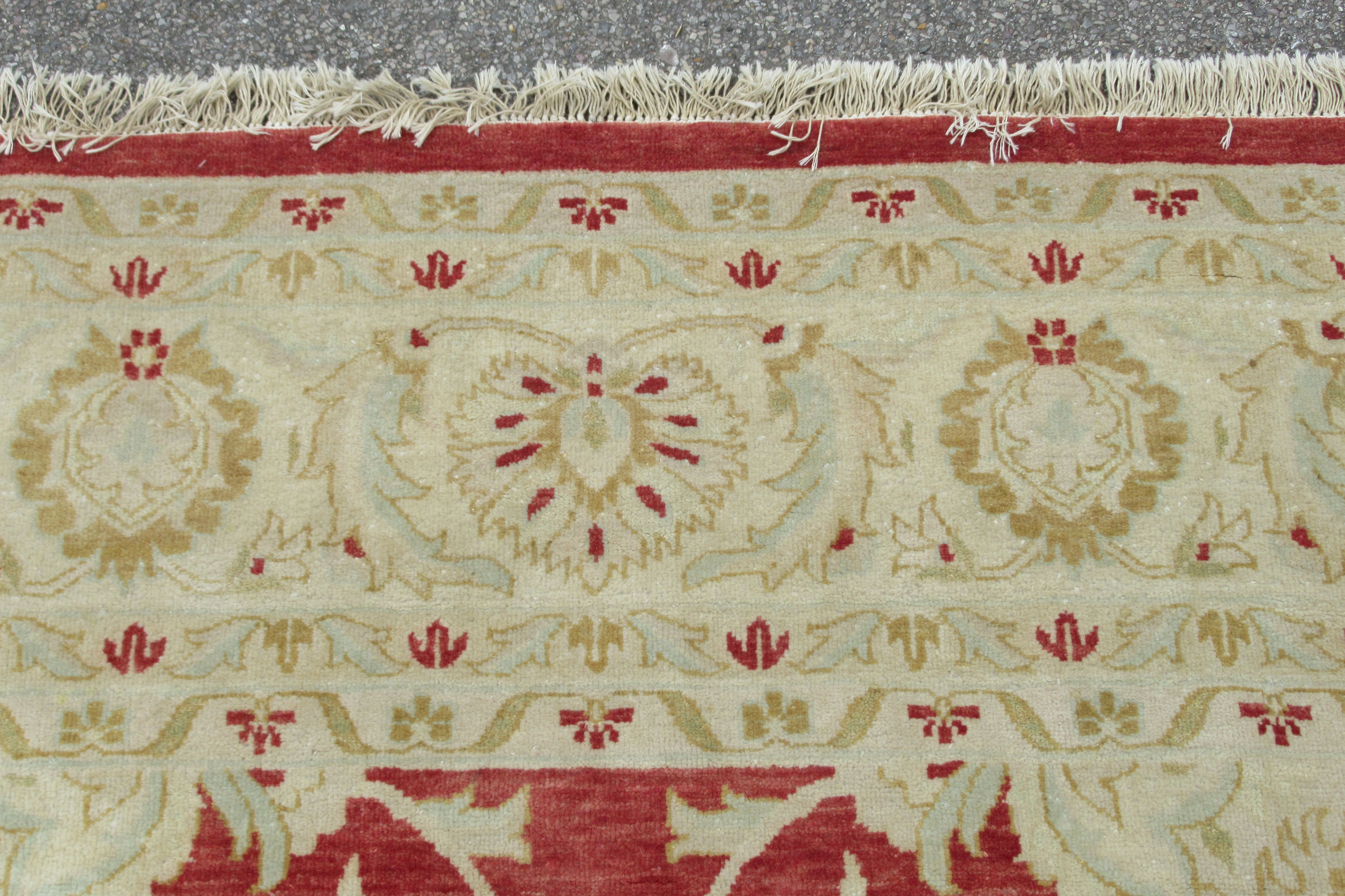 A Persian carpet, decorated with repeating stylised floral designs, on a cream and salmon coloured - Bild 4 aus 4