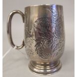 A late Victorian silver Christening mug of baluster form, having a hollow loop handle, on a