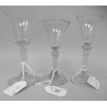 Three similar 18th/19thC wine glasses, the bell shape bowls on tapered stems and a folded foot