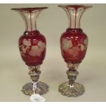 A pair of late 19thC mid European overlaid cut and engraved cranberry and clear glass ovoid shaped